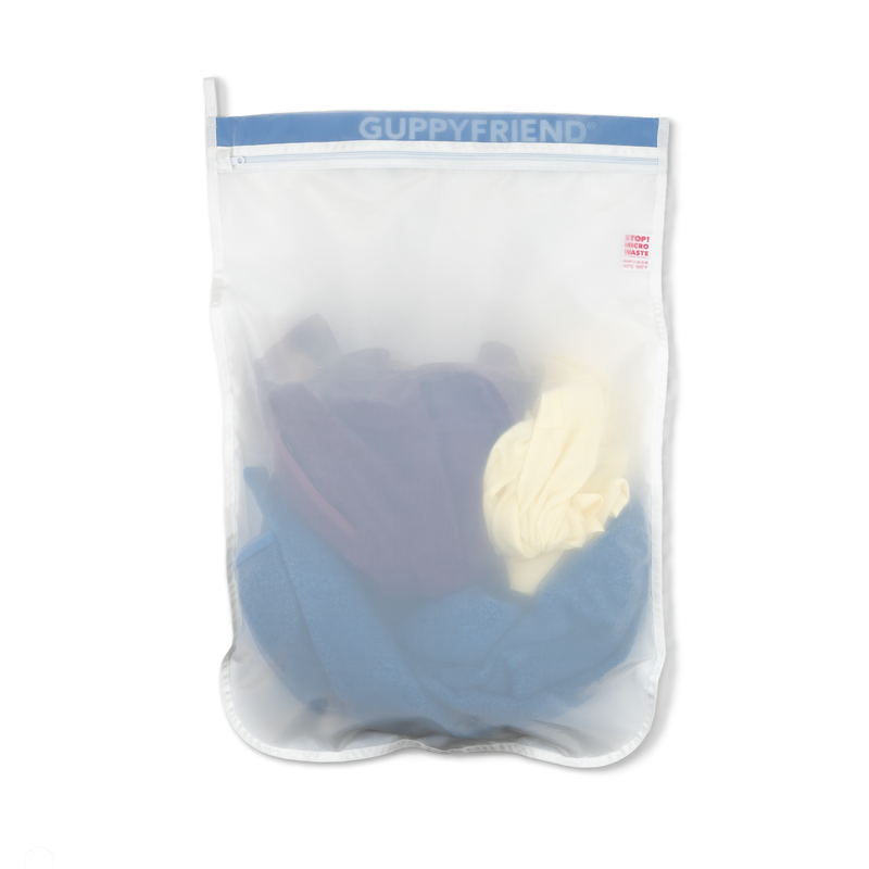 Guppyfriend product in a clear bag with blue and white items inside on a white background