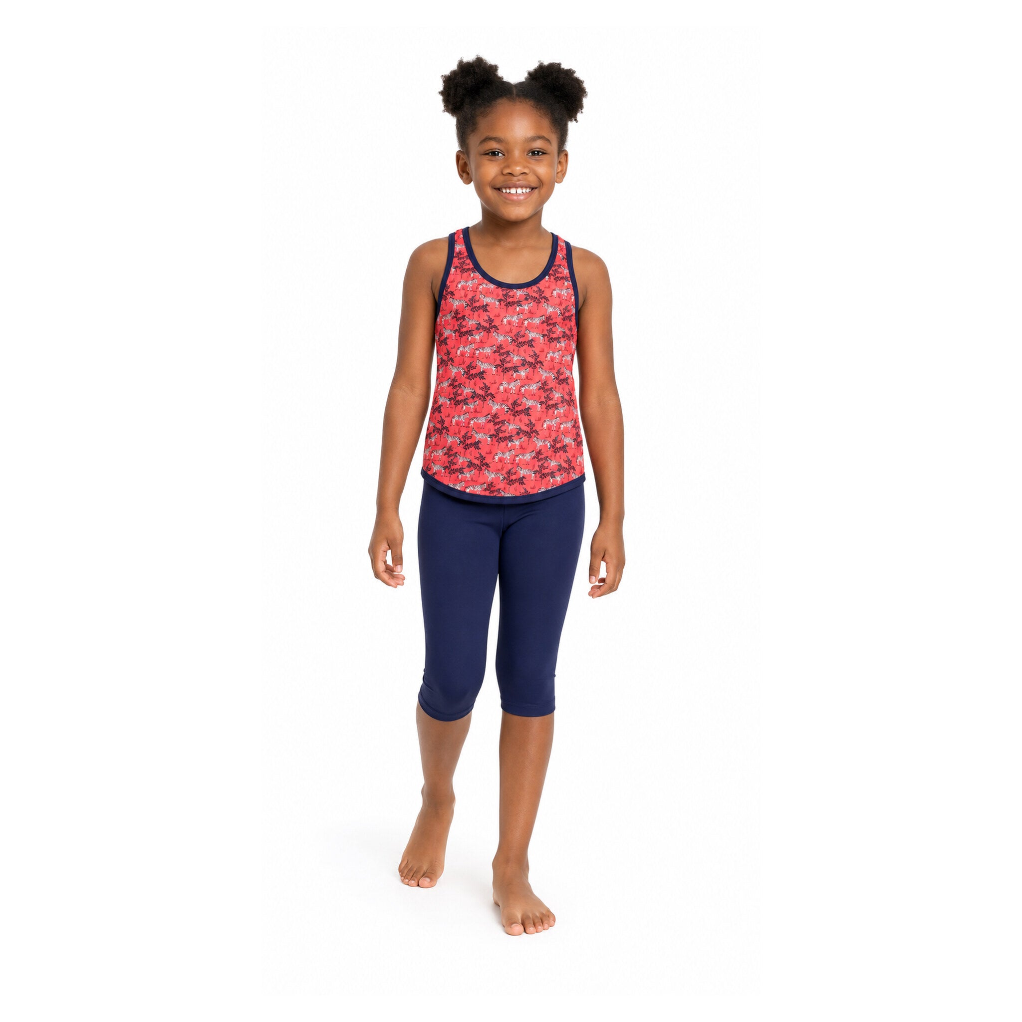 Girl wearing Kes-Vir zebra incontinence tankini with navy three-quarter swim leggings