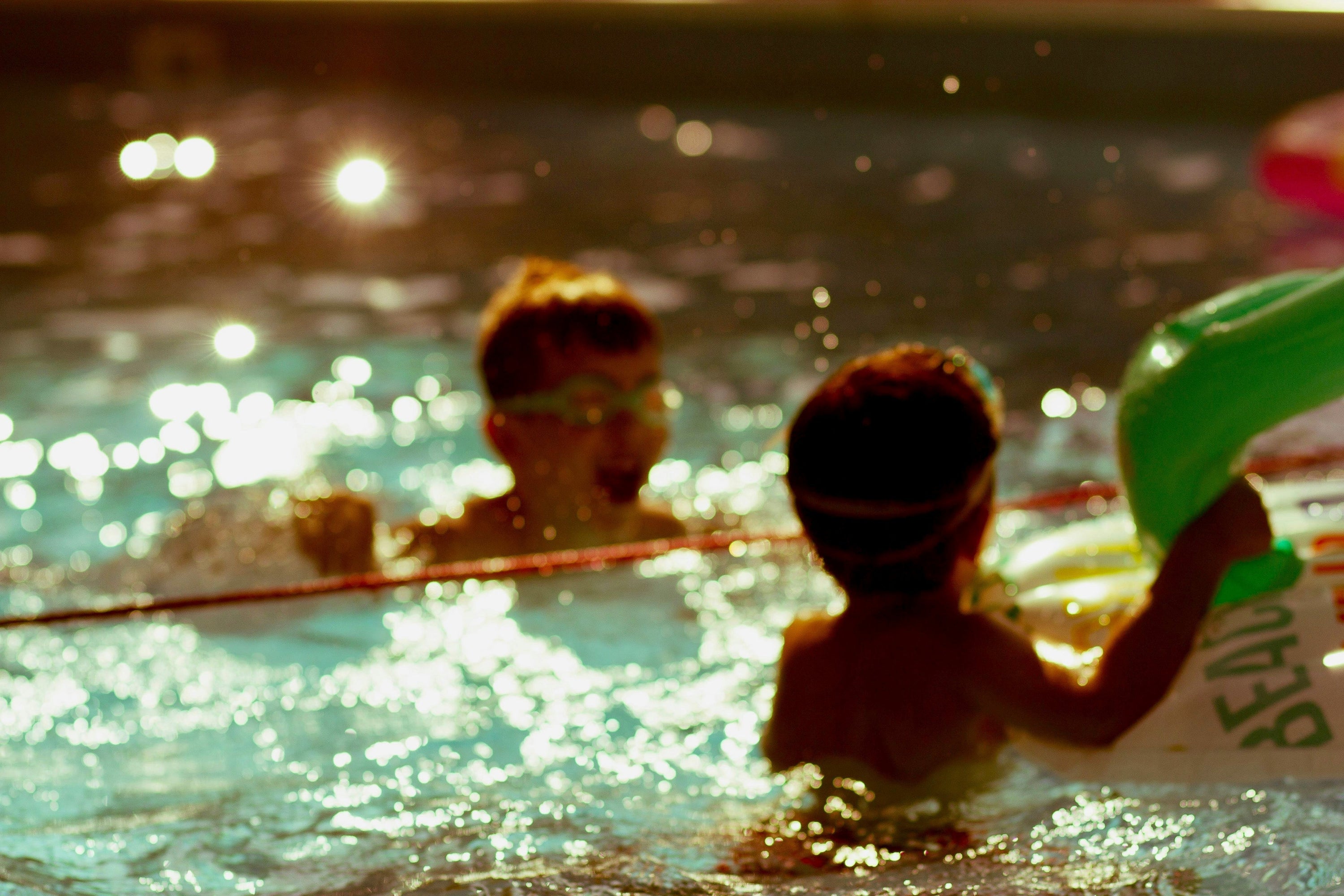 children swimming in pool