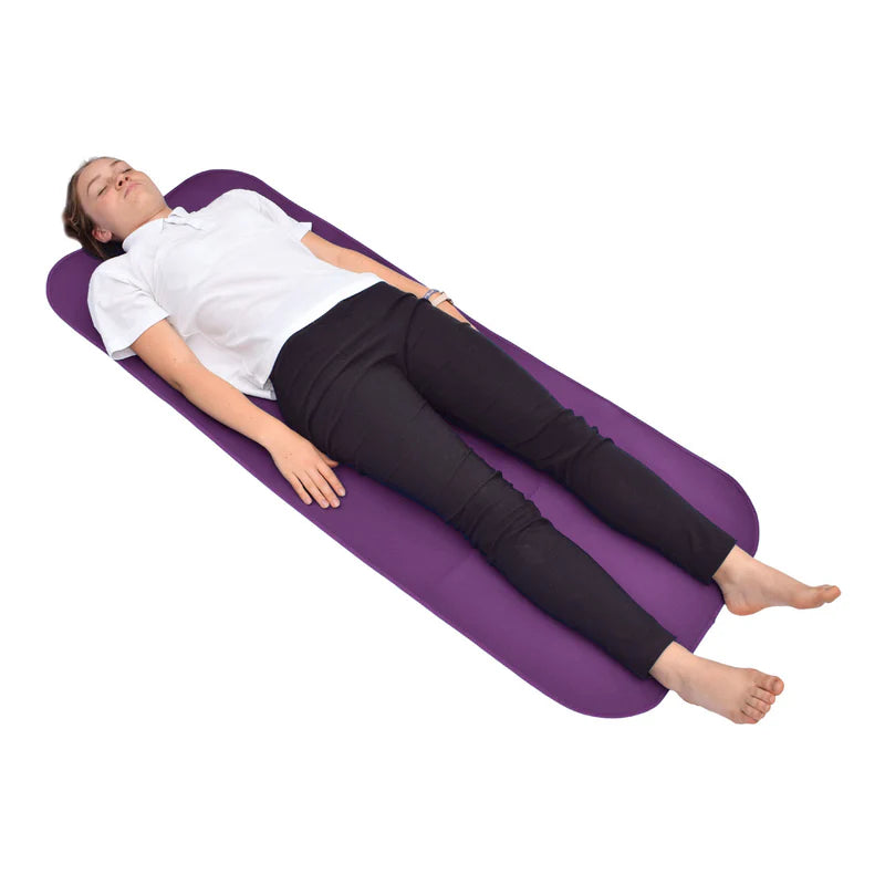 Person lying on a purple changing mat with a white background