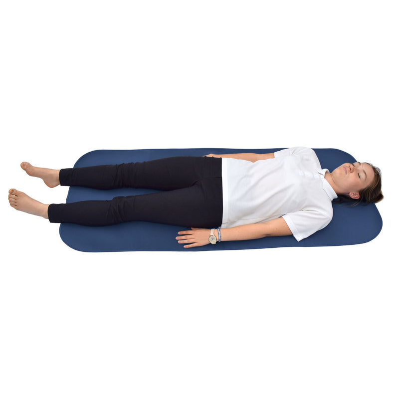 Person lying on a blue changin mat on a white background