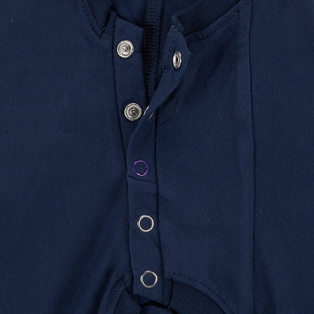 Close-up of a navy blue garment with buttons on a white background