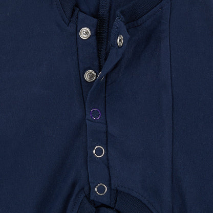 Close-up of a navy blue garment with buttons on a white background