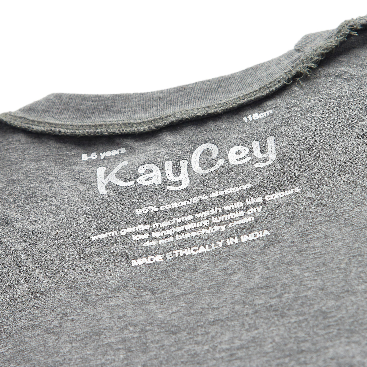 Close-up of the inside collar of a grey jumpsuit white printed text reading &