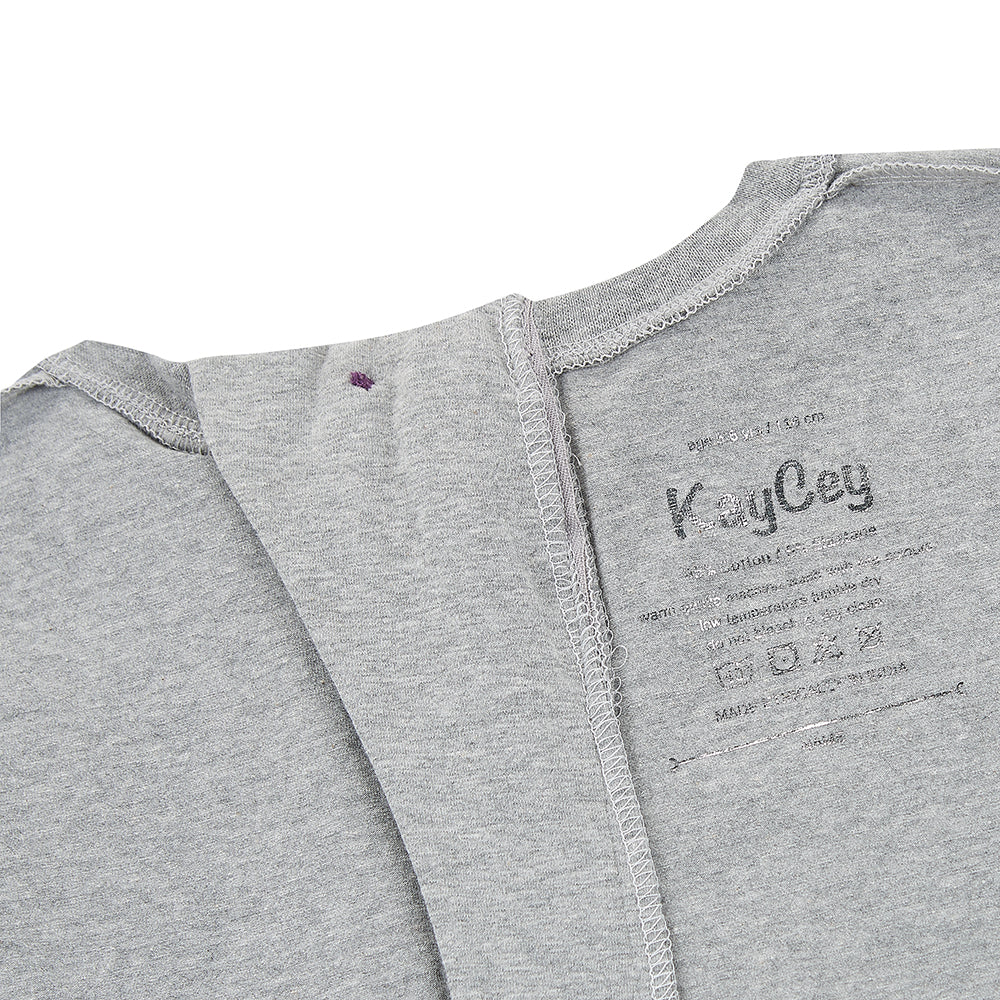 The inside of the grey piece showing the printed label and how the button seems is flat 