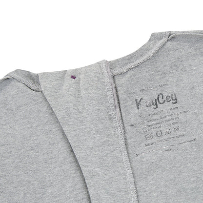 The inside of the grey piece showing the printed label and how the button seems is flat 
