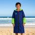 Child wearing the Konfidence kids fleece lined changing robe in navy and lime on the beach