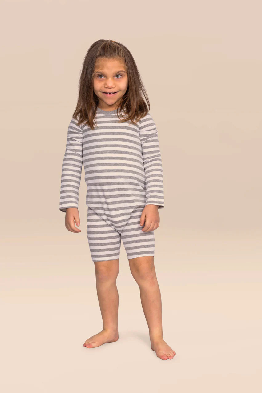 Child wearing KayCey grey and white striped long sleeve adaptive zip back jumpsuit, front view