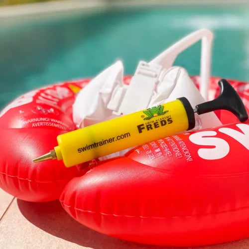 FREDS hand pump placed on a red Swimtrainer inflatable swim ring