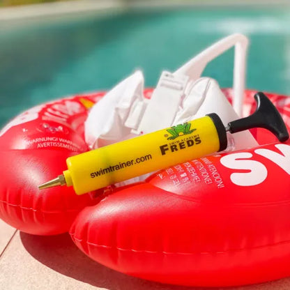 FREDS hand pump placed on a red Swimtrainer inflatable swim ring