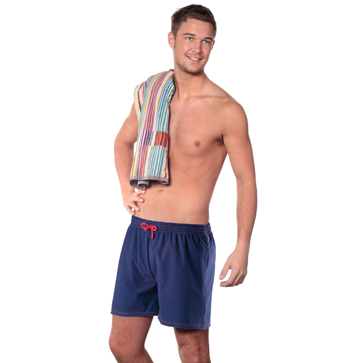 A man wearing Incontinence navy blue swim shorts with an integrated inner waterproof swim pant, holding a multi-colored towel.