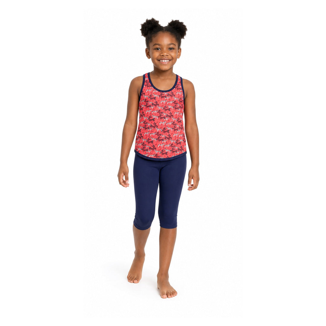 Girl wearing Kes-Vir zebra incontinence tankini with navy three-quarter swim leggings